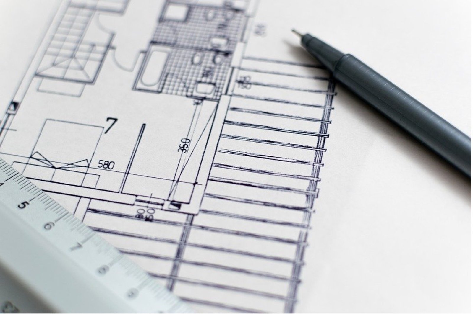 A pointer and ruler on a construction plan sheet 